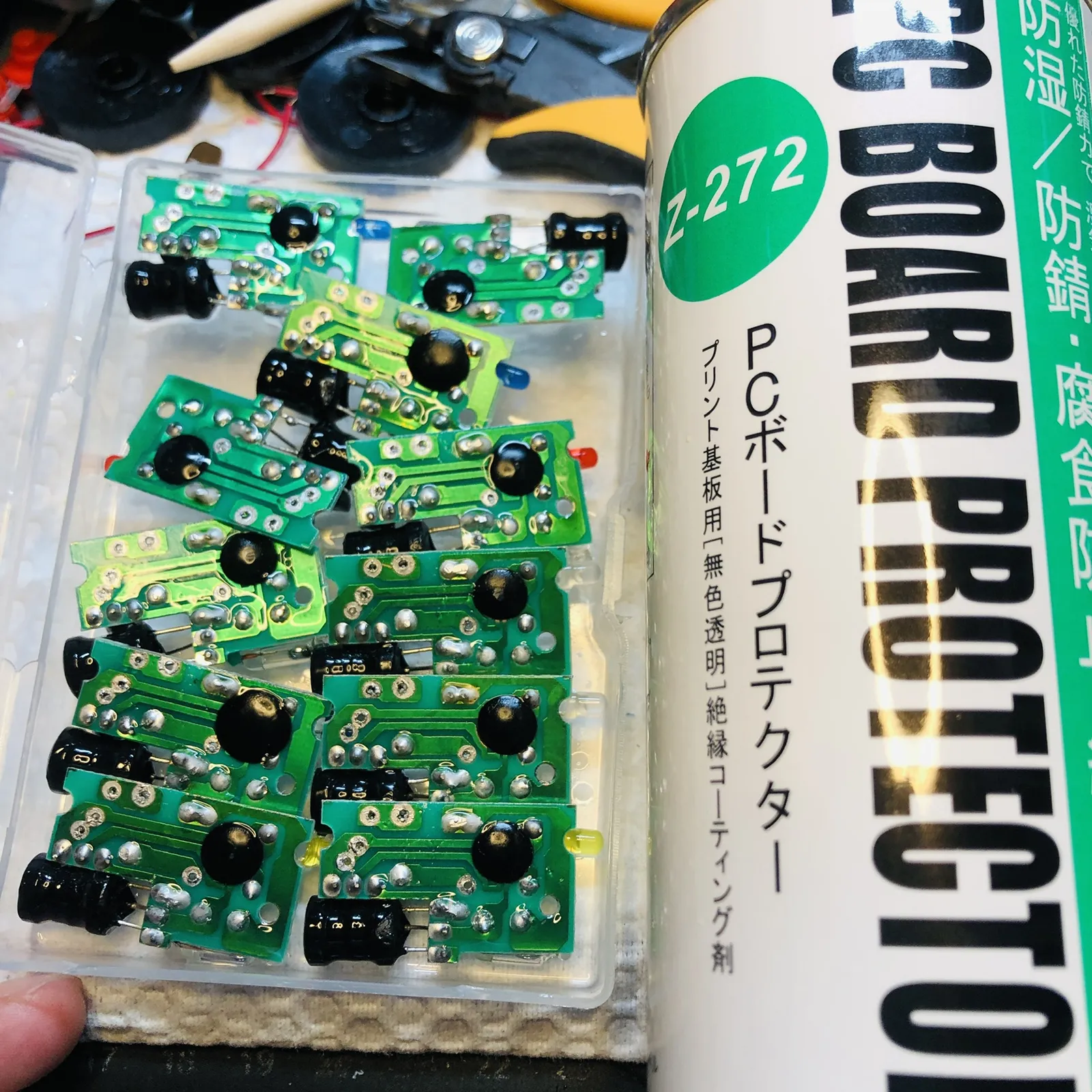 緑の基板が並び、横に防錆スプレーの缶があります