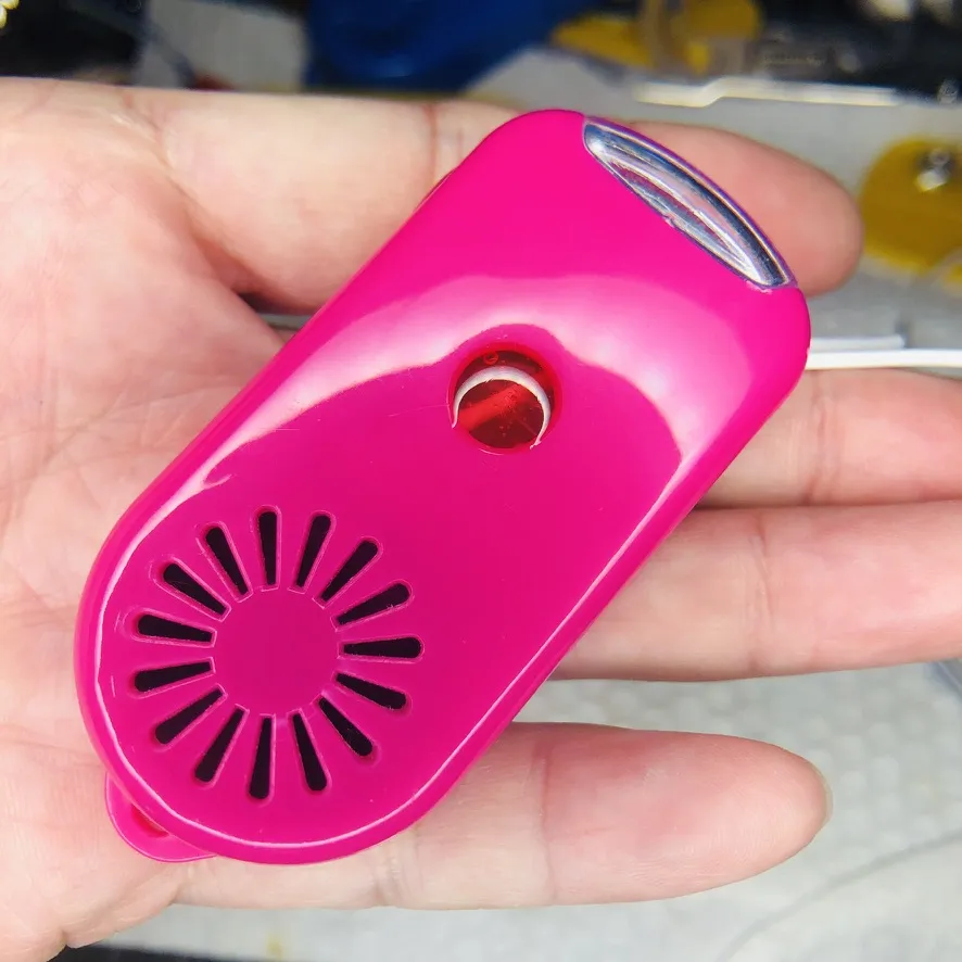 手のひらに乗せた、ピンクの本体の裏側。放射状のスピーカー穴